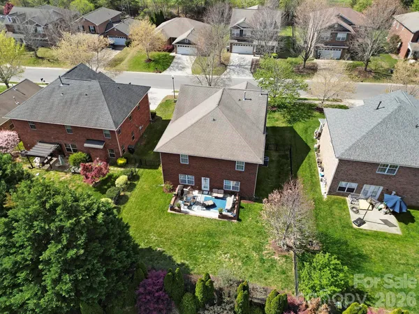 an aerial view of a house with garden space and lake view