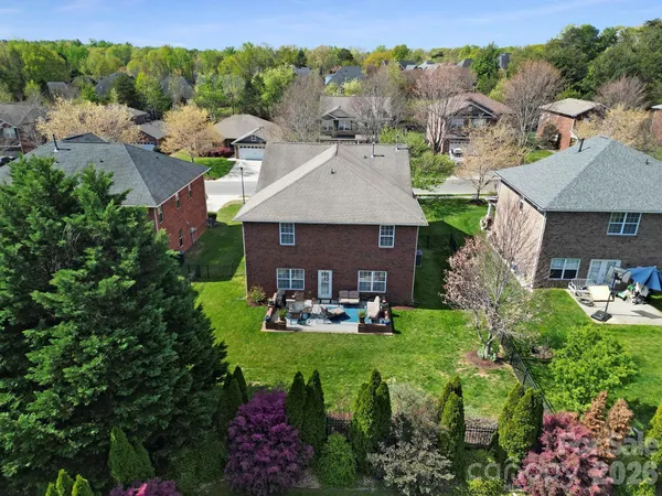 a aerial view of a house with table and chairs under an umbrella
