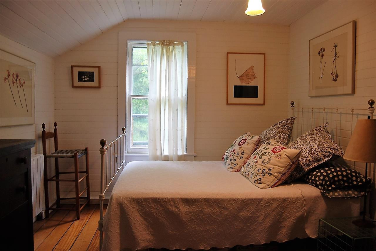 3424 Cooper Street Stone Ridge, NY 12484 - Photo 13 of 24 a bedroom with a bed and wooden floor