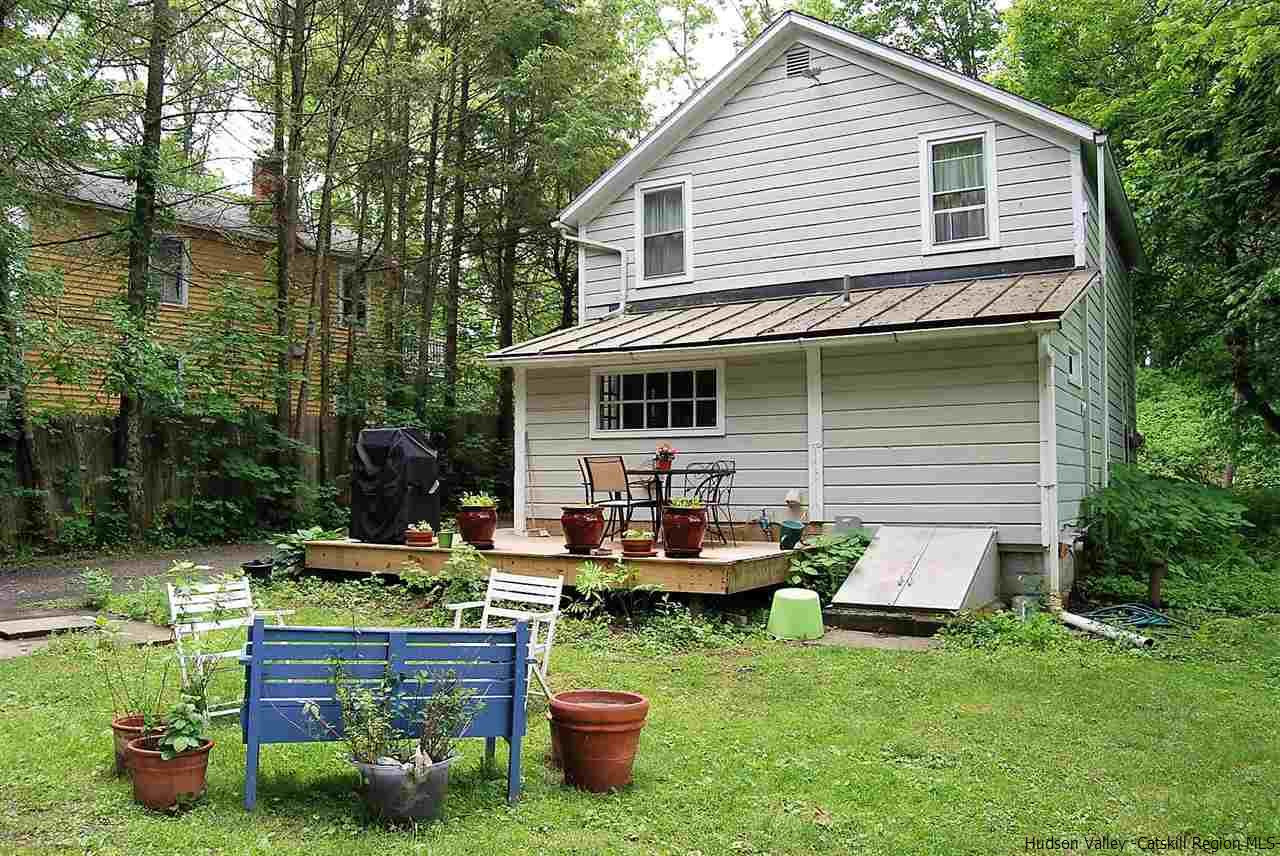 3424 Cooper Street Stone Ridge, NY 12484 - Photo 20 of 24 a view of a house with backyard sitting area and garden
