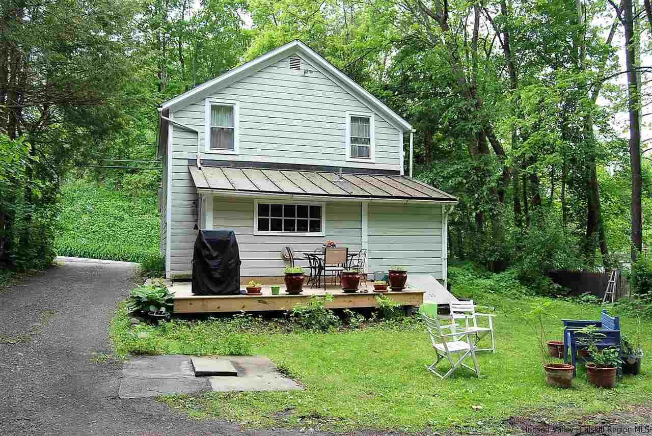3424 Cooper Street Stone Ridge, NY 12484 - Photo 22 of 24 a view of a house with a yard chairs and a table and chairs