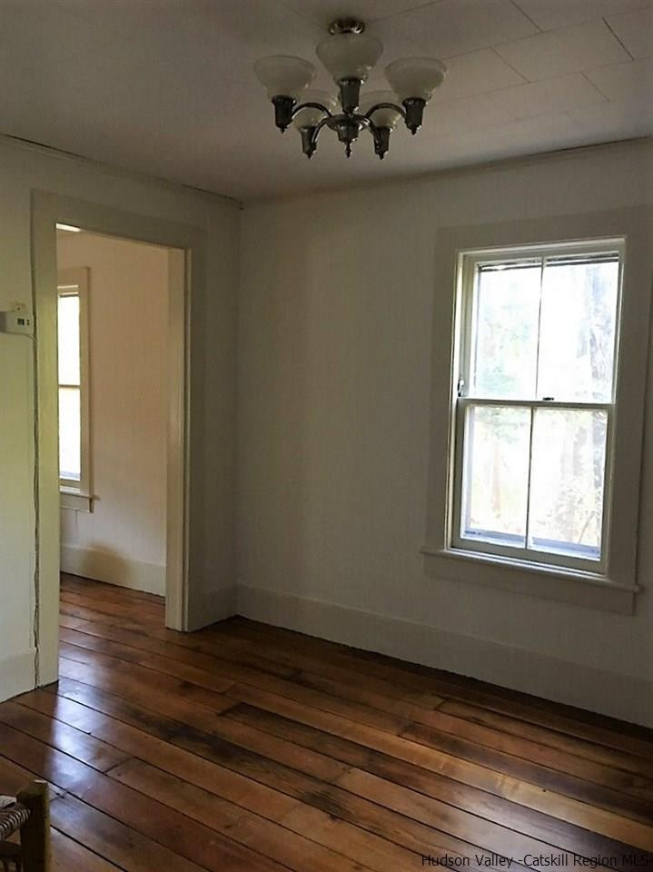 3424 Cooper Street Stone Ridge, NY 12484 - Photo 8 of 24 an empty room with wooden floor and windows