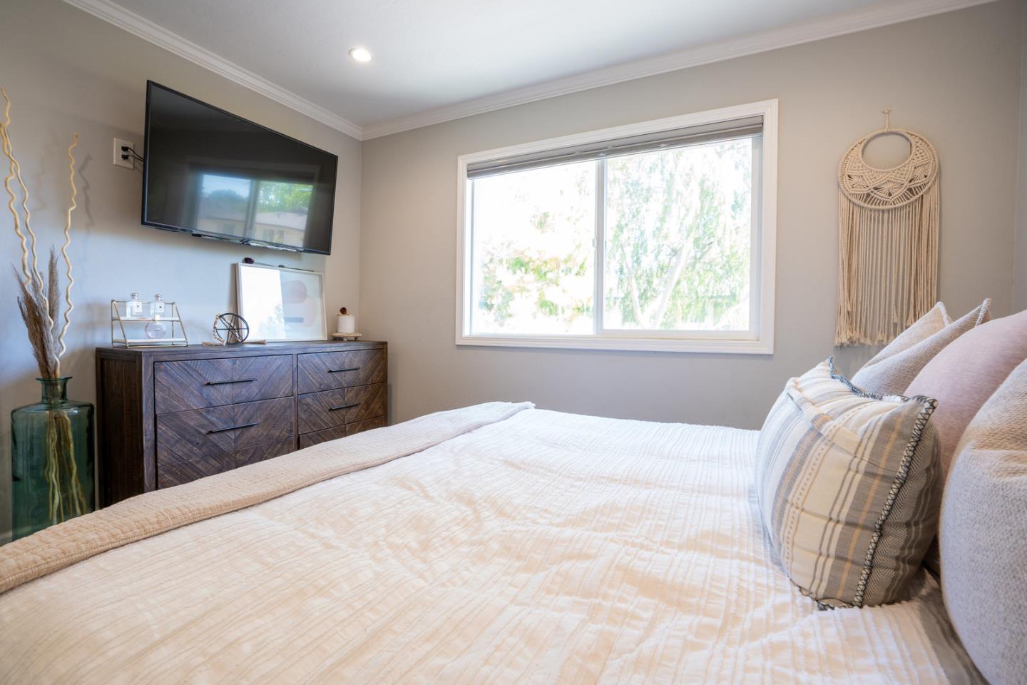 230 Watson Drive, Unit 4 Campbell, CA 95008 - Photo 14 of 17 a bedroom with a large bed and a flat tv screen on dresser