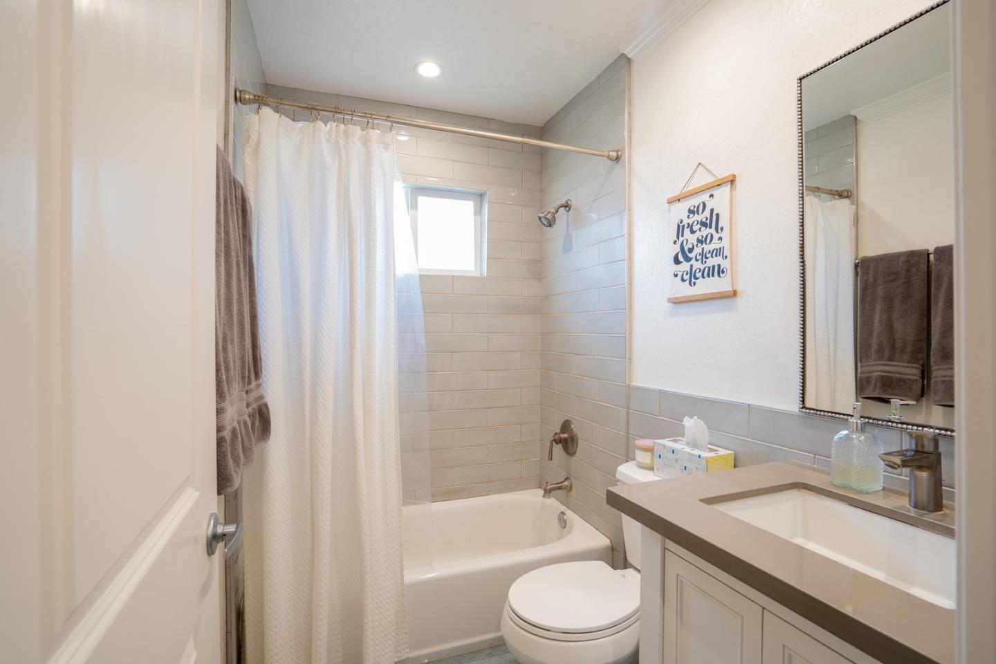 230 Watson Drive, Unit 4 Campbell, CA 95008 - Photo 10 of 17 a bathroom with a granite countertop sink toilet and shower
