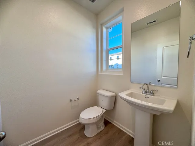 a bathroom with a sink toilet and mirror