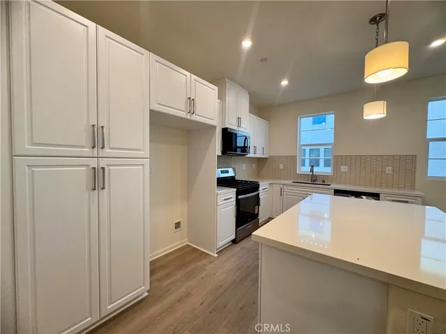 a kitchen with cabinets and stainless steel appliances