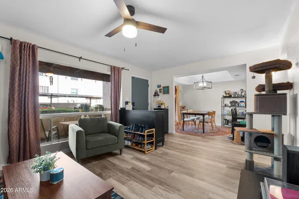 a living room with furniture and a wooden floor