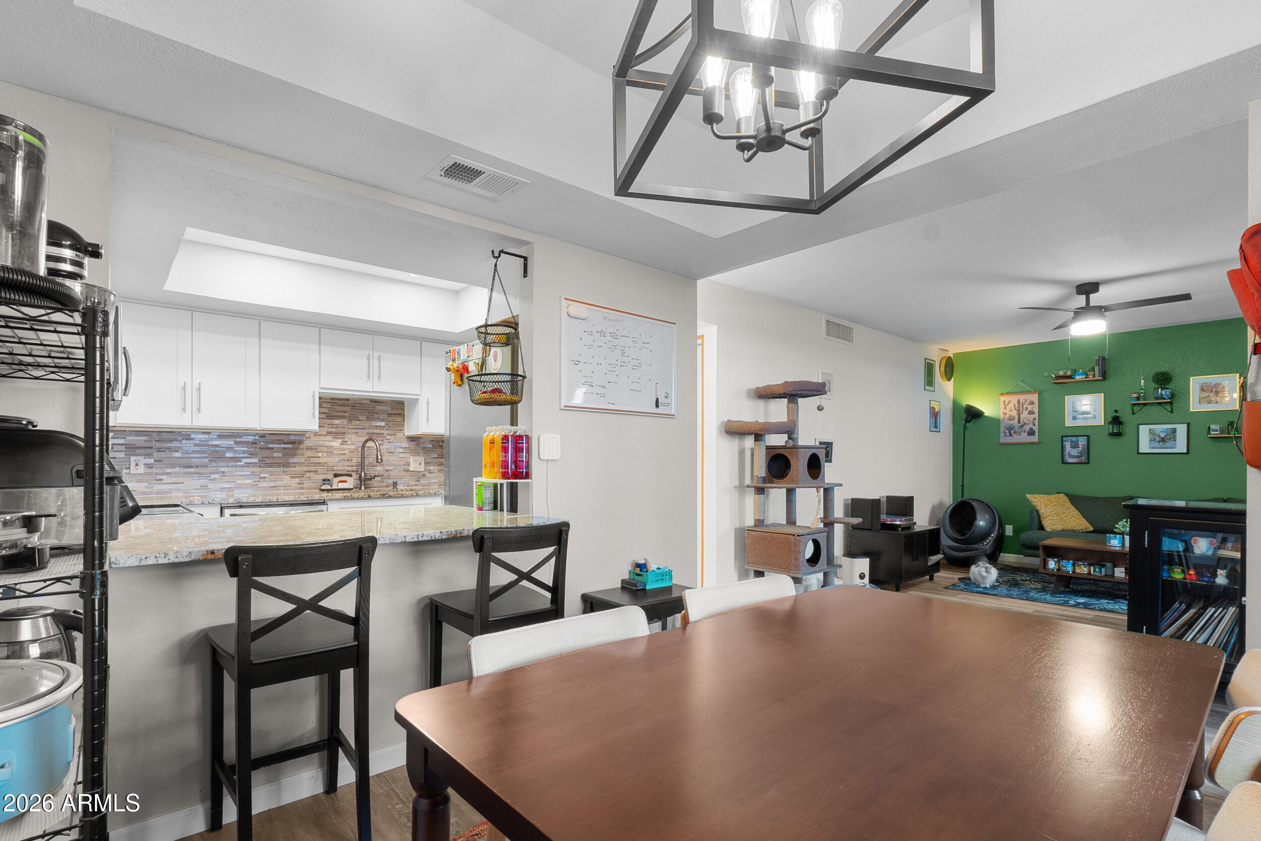 202 East Ruth Avenue, Unit 2 Phoenix, AZ 85020 - Photo 5 of 25 a kitchen with a table chairs and wooden floor
