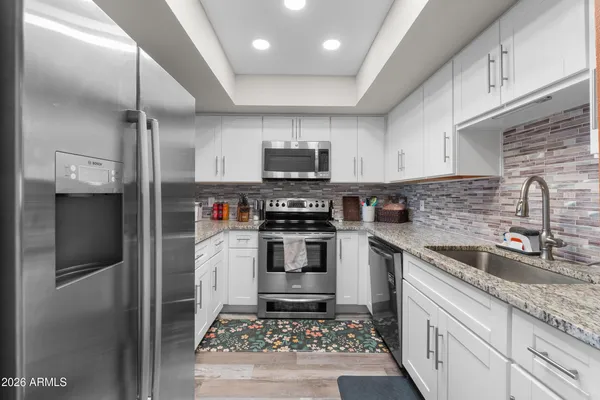 a kitchen with a table chairs and wooden floor
