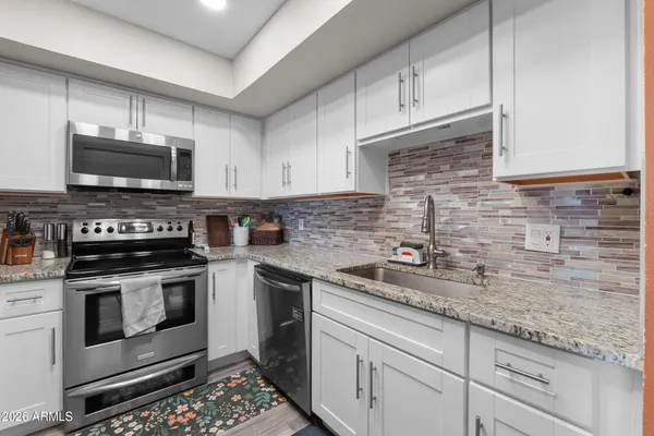 a kitchen with a sink stove and refrigerator