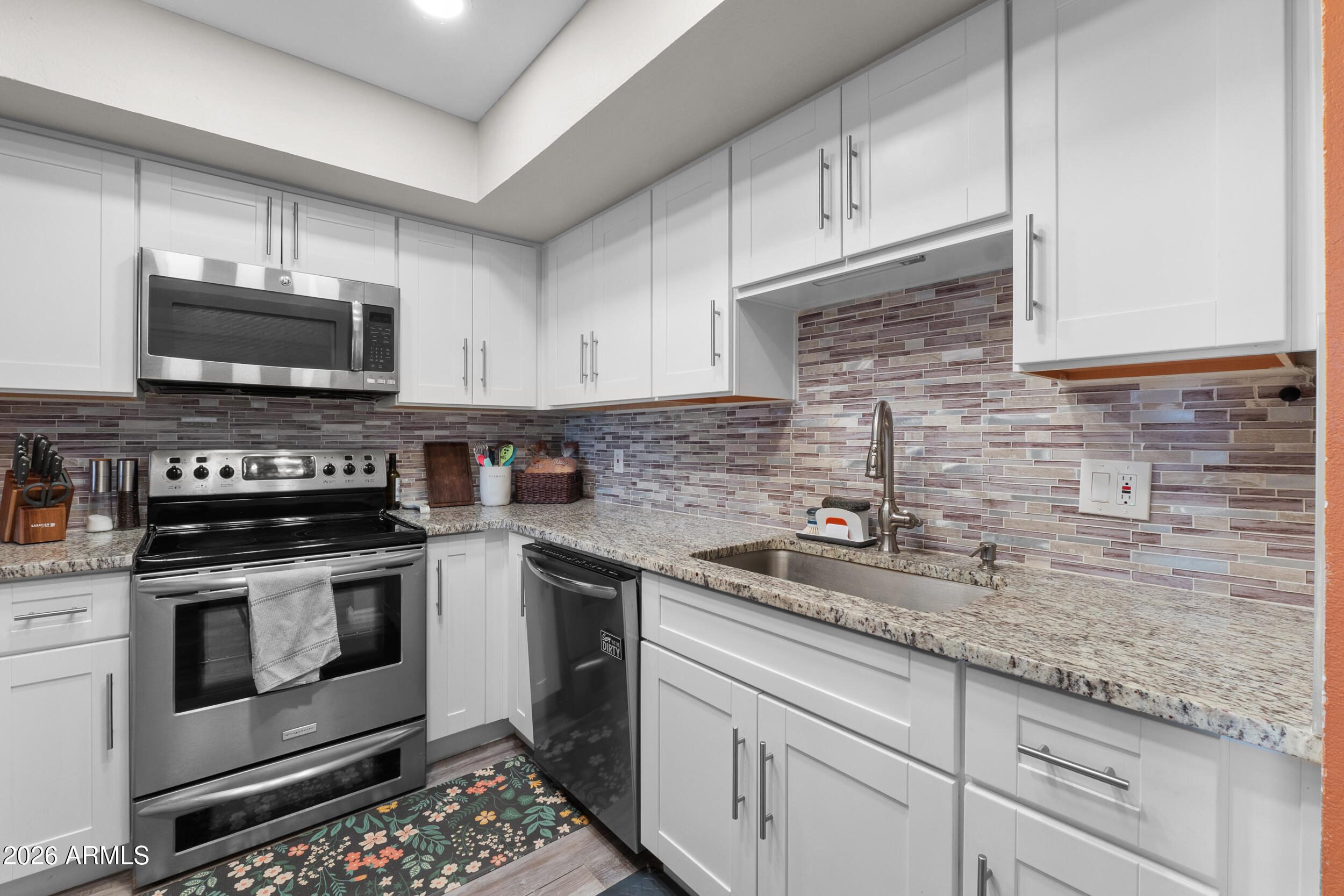 202 East Ruth Avenue, Unit 2 Phoenix, AZ 85020 - Photo 7 of 25 a kitchen with granite countertop a sink stove and microwave
