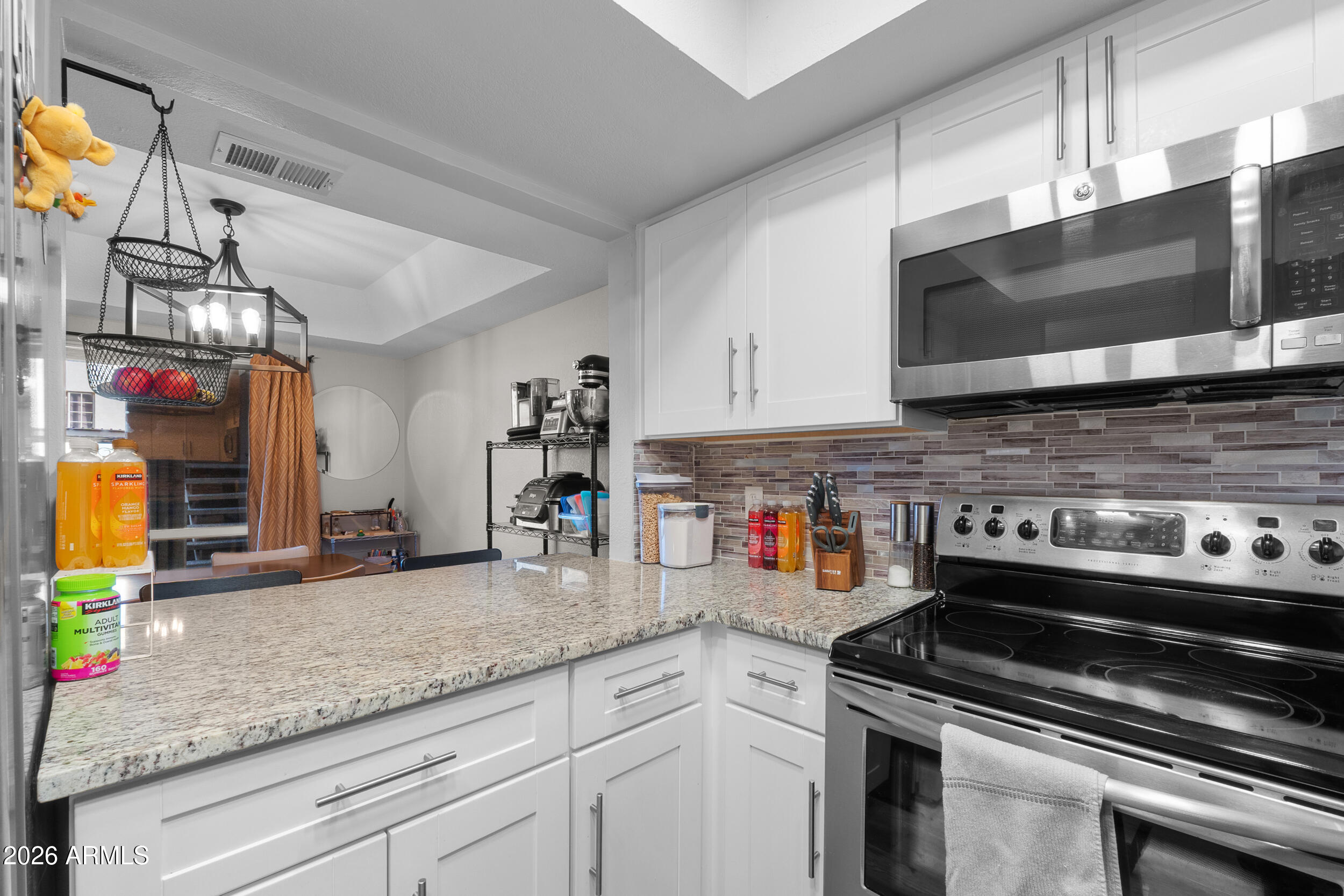 202 East Ruth Avenue, Unit 2 Phoenix, AZ 85020 - Photo 9 of 25 a kitchen with stainless steel appliances granite countertop a sink a stove and cabinets