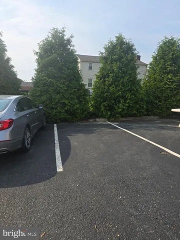 a view of a street with a car parked on the road