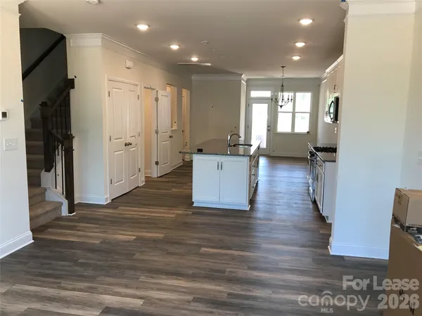 a room with wooden floor and windows