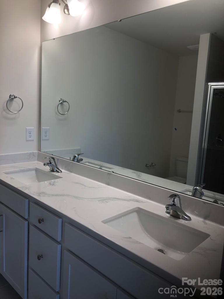 190 Waterlynn Ridge Road, Unit C Mooresville, NC 28117 - Photo 7 of 13 a bathroom with a sink and a mirror