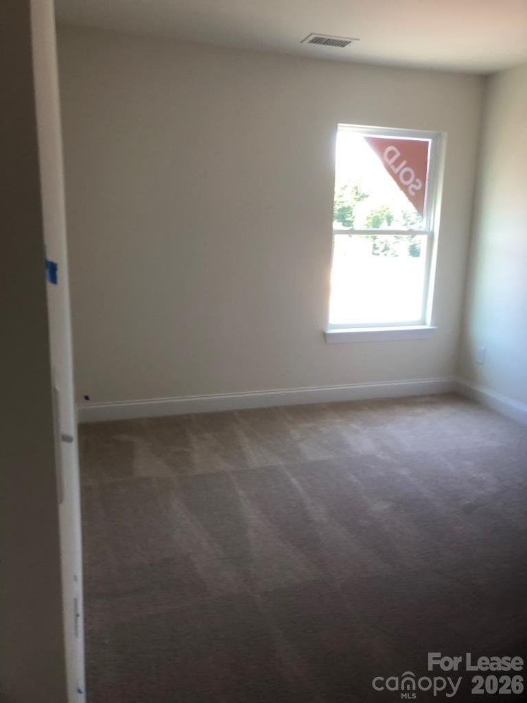 190 Waterlynn Ridge Road, Unit C Mooresville, NC 28117 - Photo 9 of 13 an empty room with a window