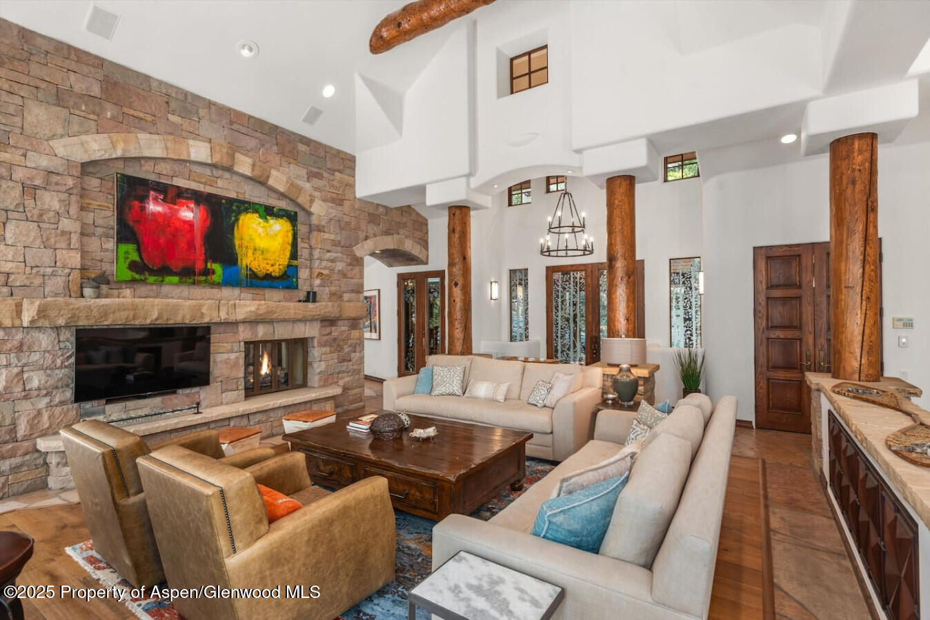 27 Timber Ridge Lane Snowmass Village, CO 81615 - Photo 16 of 40 a living room with furniture a fireplace and a flat screen tv