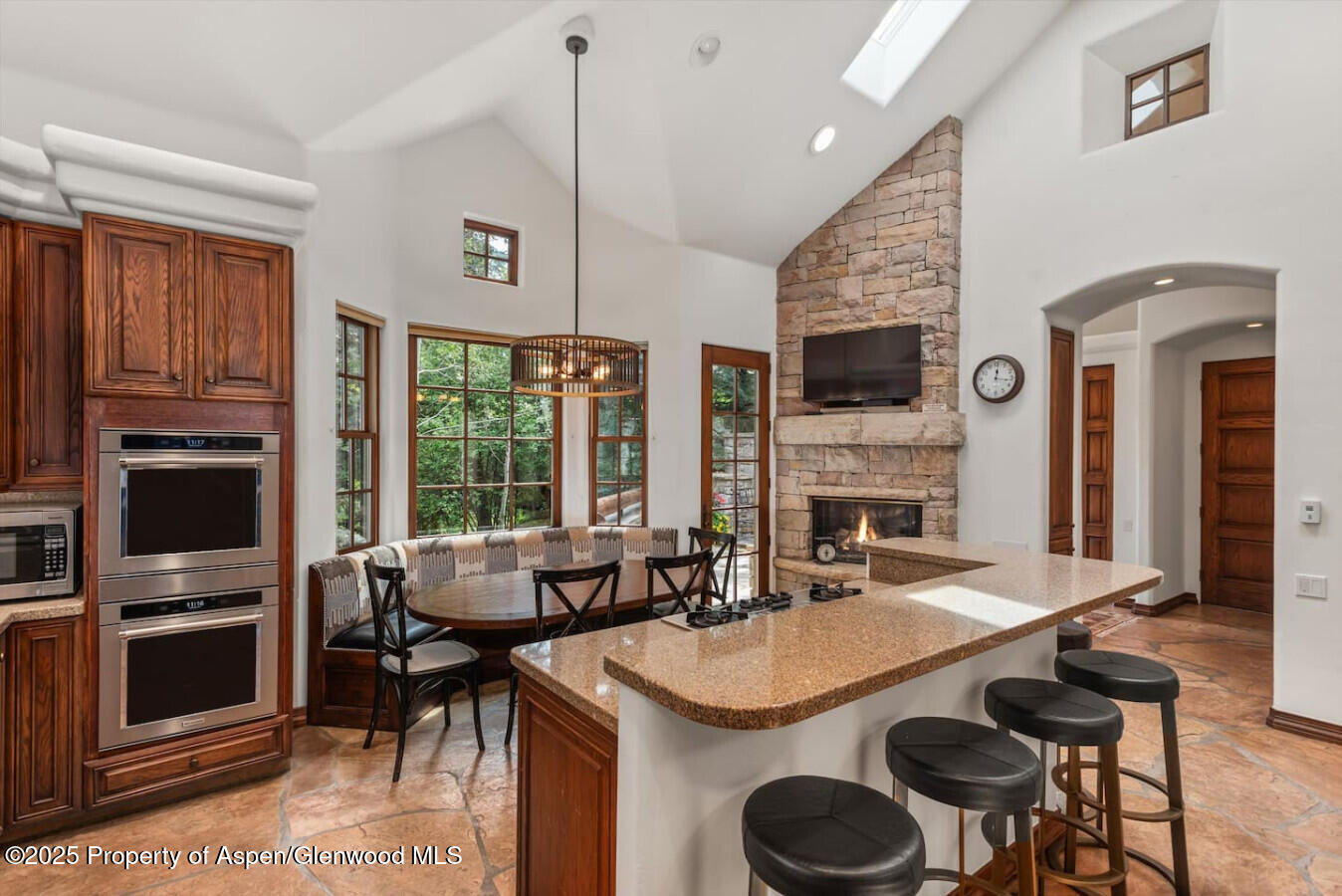 27 Timber Ridge Lane Snowmass Village, CO 81615 - Photo 21 of 40 a view of kitchen island dining area kitchen island stainless steel appliances wooden floor and living room view