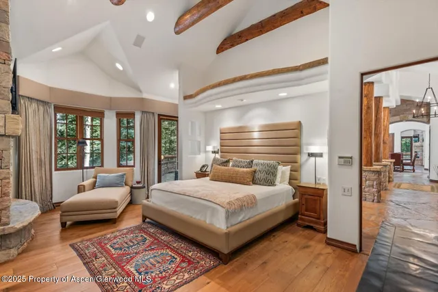 a bedroom with a bed and glass door