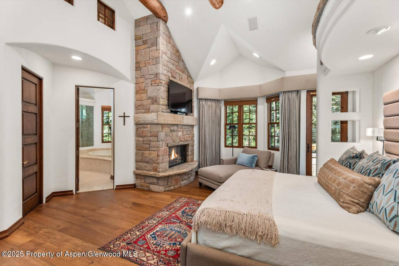 27 Timber Ridge Lane Snowmass Village, CO 81615 - Photo 27 of 40 a bedroom with a bed and glass door