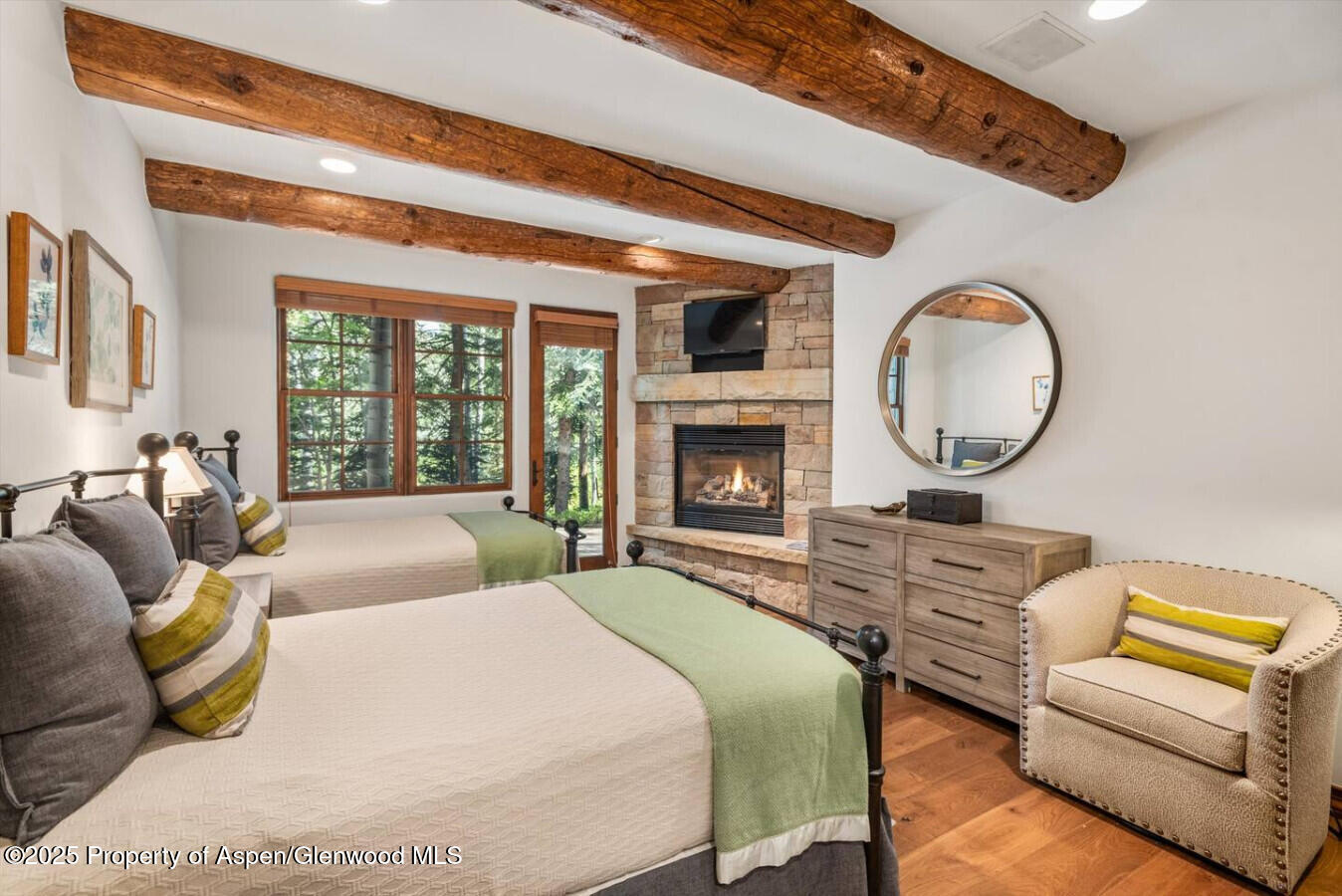 27 Timber Ridge Lane Snowmass Village, CO 81615 - Photo 31 of 40 a spacious bedroom with a bed a couch and a large window