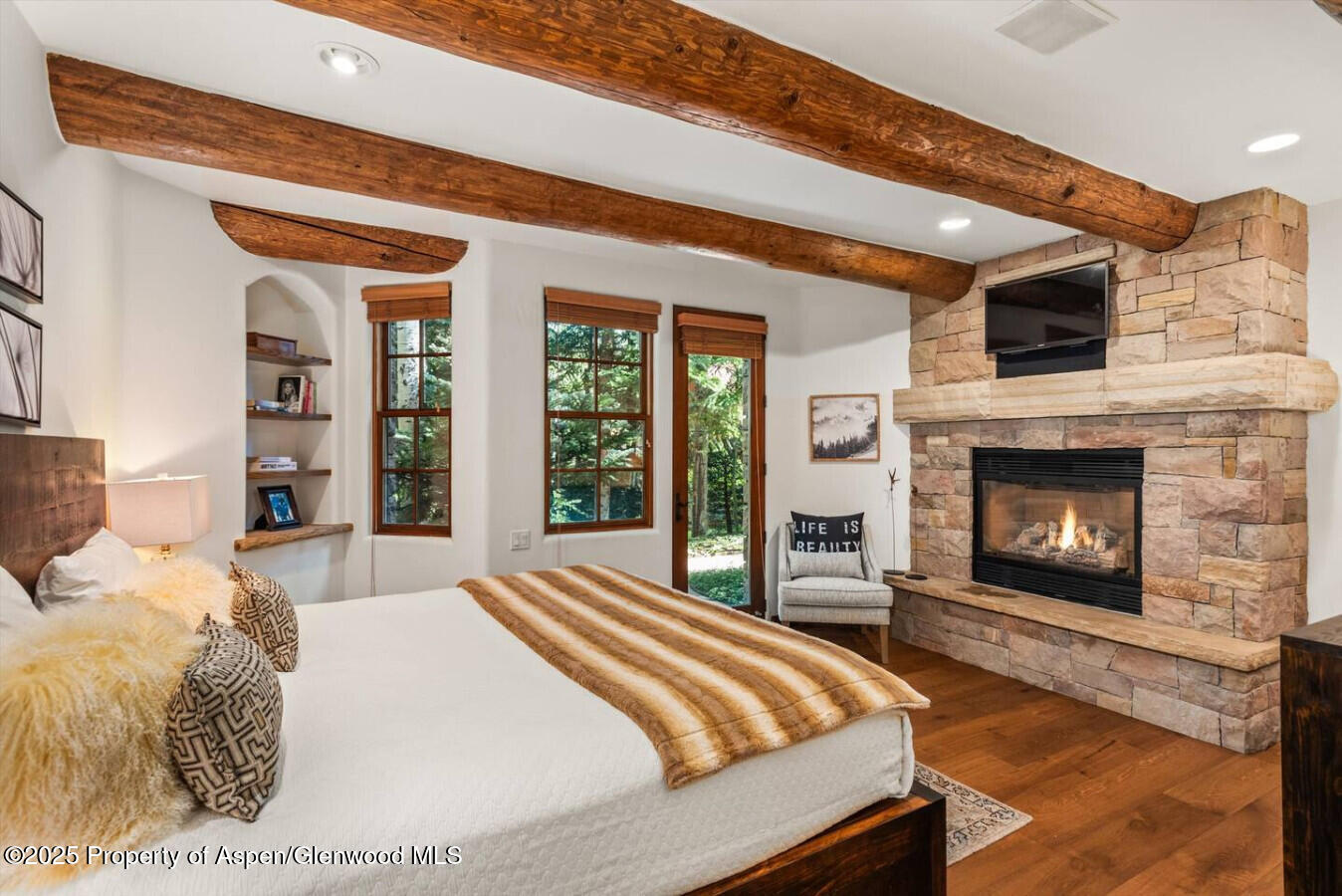 27 Timber Ridge Lane Snowmass Village, CO 81615 - Photo 37 of 40 a bed sitting in a spacious bedroom next to a fireplace