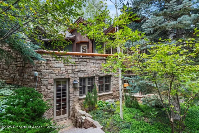 front view of a house with a tree