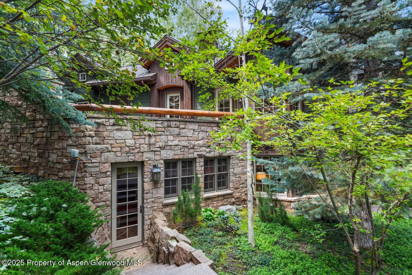 27 Timber Ridge Lane Snowmass Village, CO 81615 - Photo 5 of 40 front view of a house with a tree