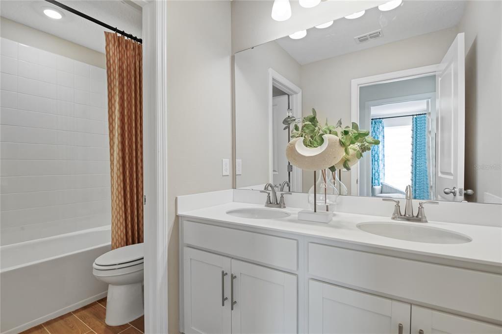 5131 Spring Maiden Circle Apollo Beach, FL 33572 - Photo 16 of 25 a bathroom with a sink a toilet and shower