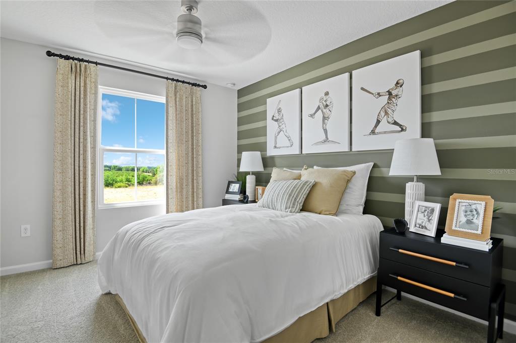 5131 Spring Maiden Circle Apollo Beach, FL 33572 - Photo 17 of 25 a large bed sitting in a bedroom next to a window