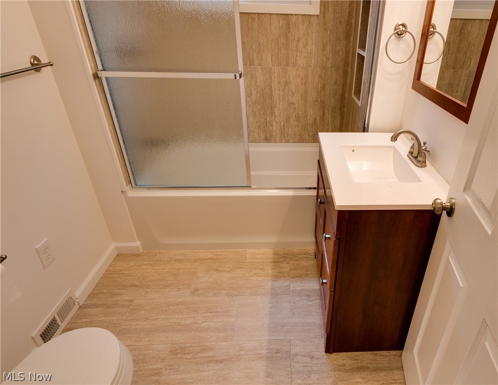 38705 Chardon Road Willoughby Hills, OH 44094 - Photo 13 of 35 Completely updated bathroom with ceramic tile for flooring and ceramic tile in shower with sliding door. Vanity complements the room with matching mirror and one piece white counter top