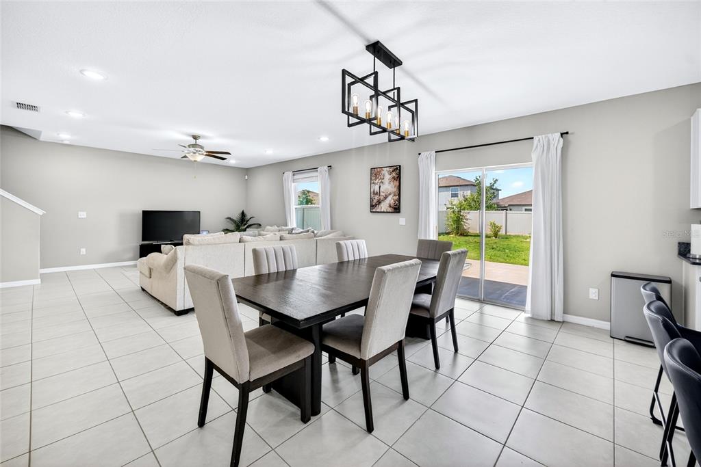 31724 Sun Kettle Loop Wesley Chapel, FL 33545 - Photo 9 of 49 a view of a dining room with furniture and a chandelier