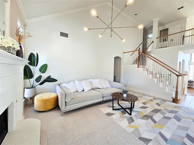 a living room with furniture and a chandelier