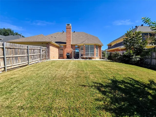 a view of a house with a big yard and potted plants