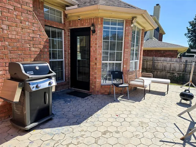 a backyard of a house with outdoor seating