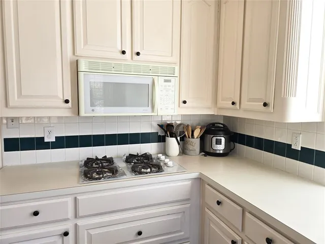a kitchen with a stove and cabinets