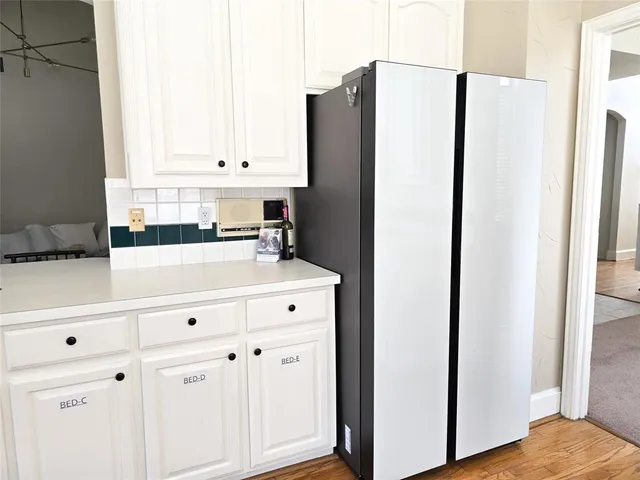 a kitchen with cabinets and a refrigerator