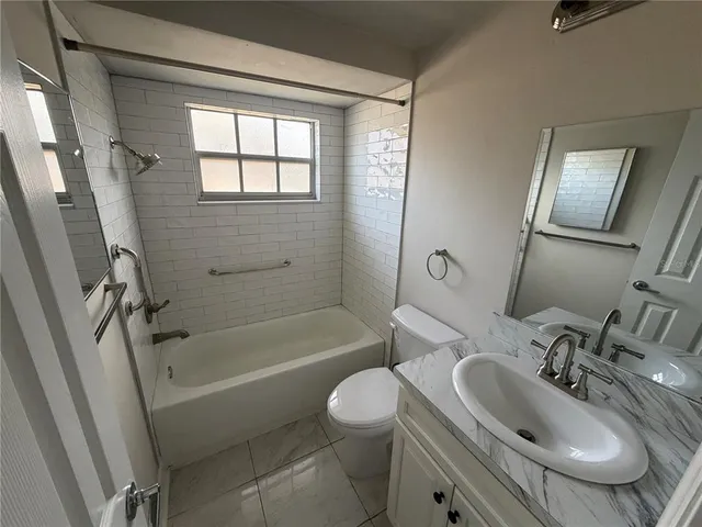 a bathroom with a sink toilet tub and shower