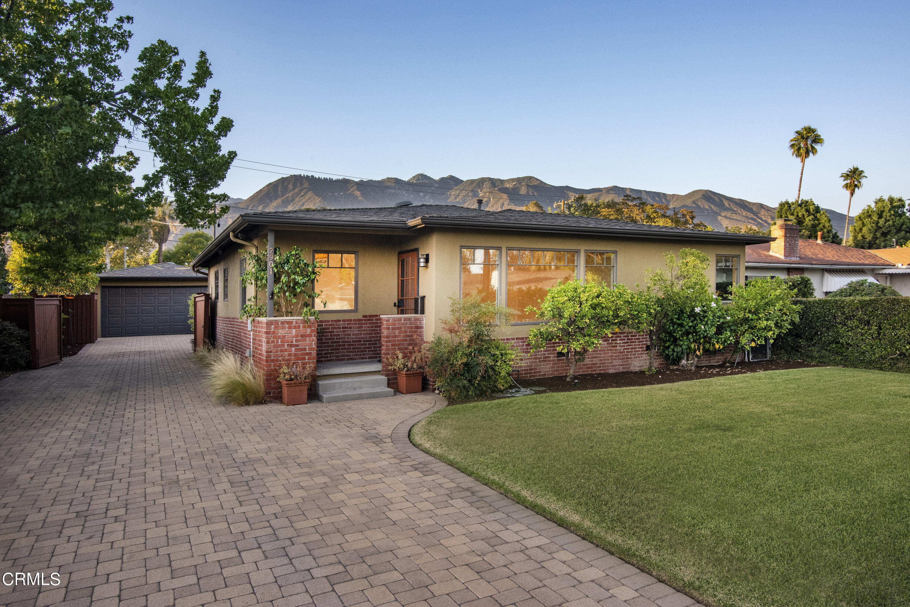 a view of a house with a yard and a patio