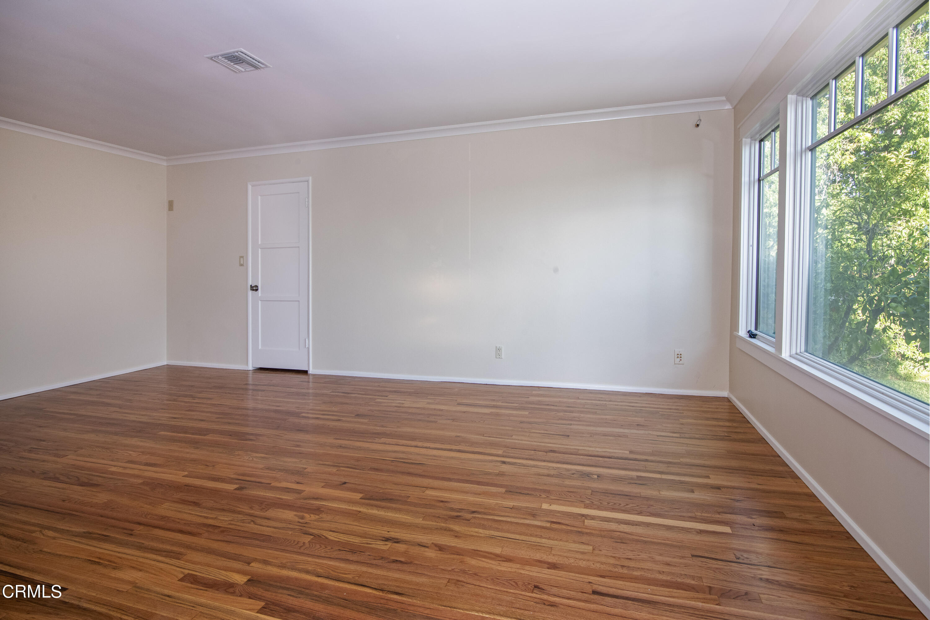 2901 Paloma Street Pasadena, CA 91107 - Photo 13 of 41 a view of an empty room with wooden floor and a window
