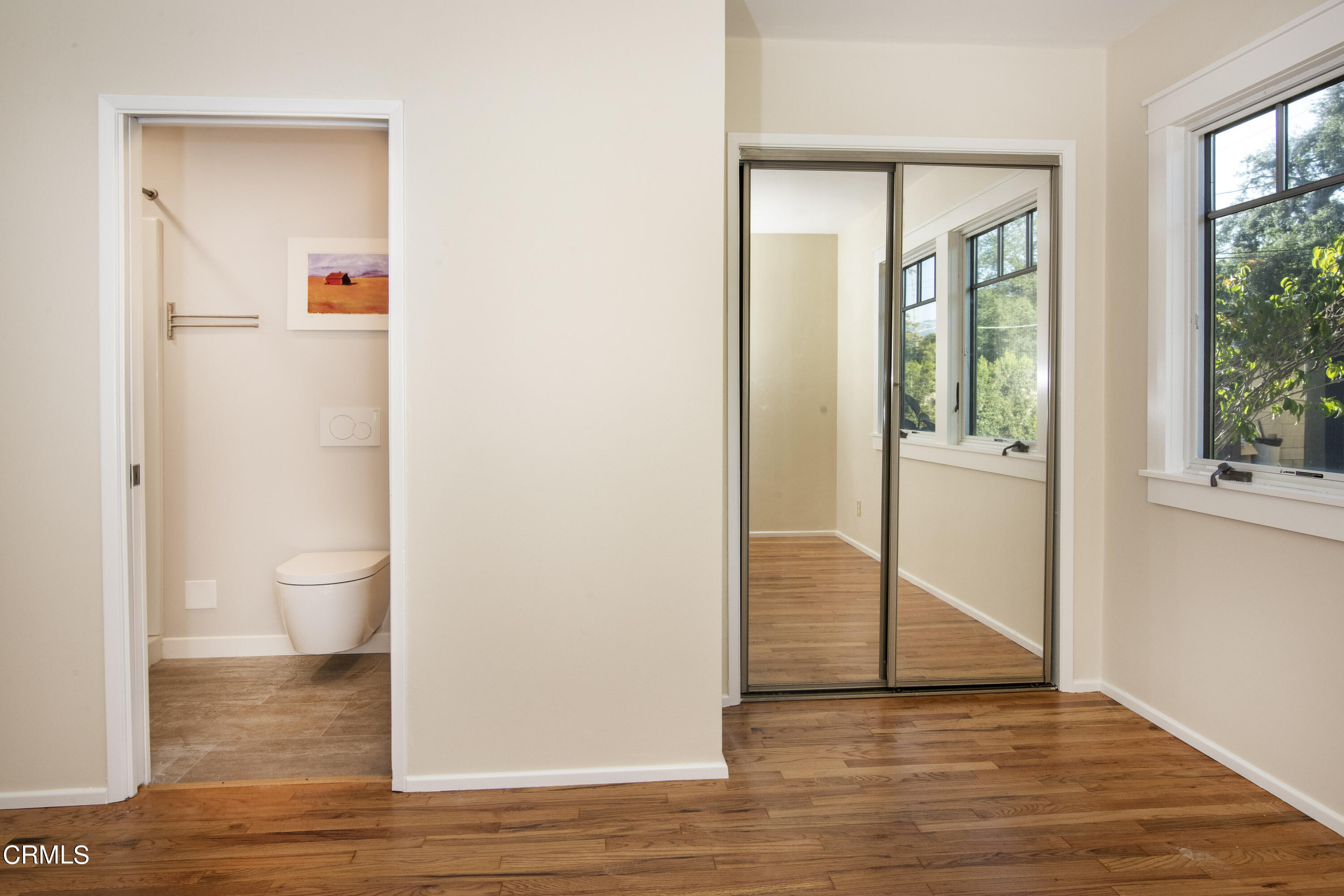 2901 Paloma Street Pasadena, CA 91107 - Photo 26 of 41 a view of a hallway with wooden floor and a bathroom
