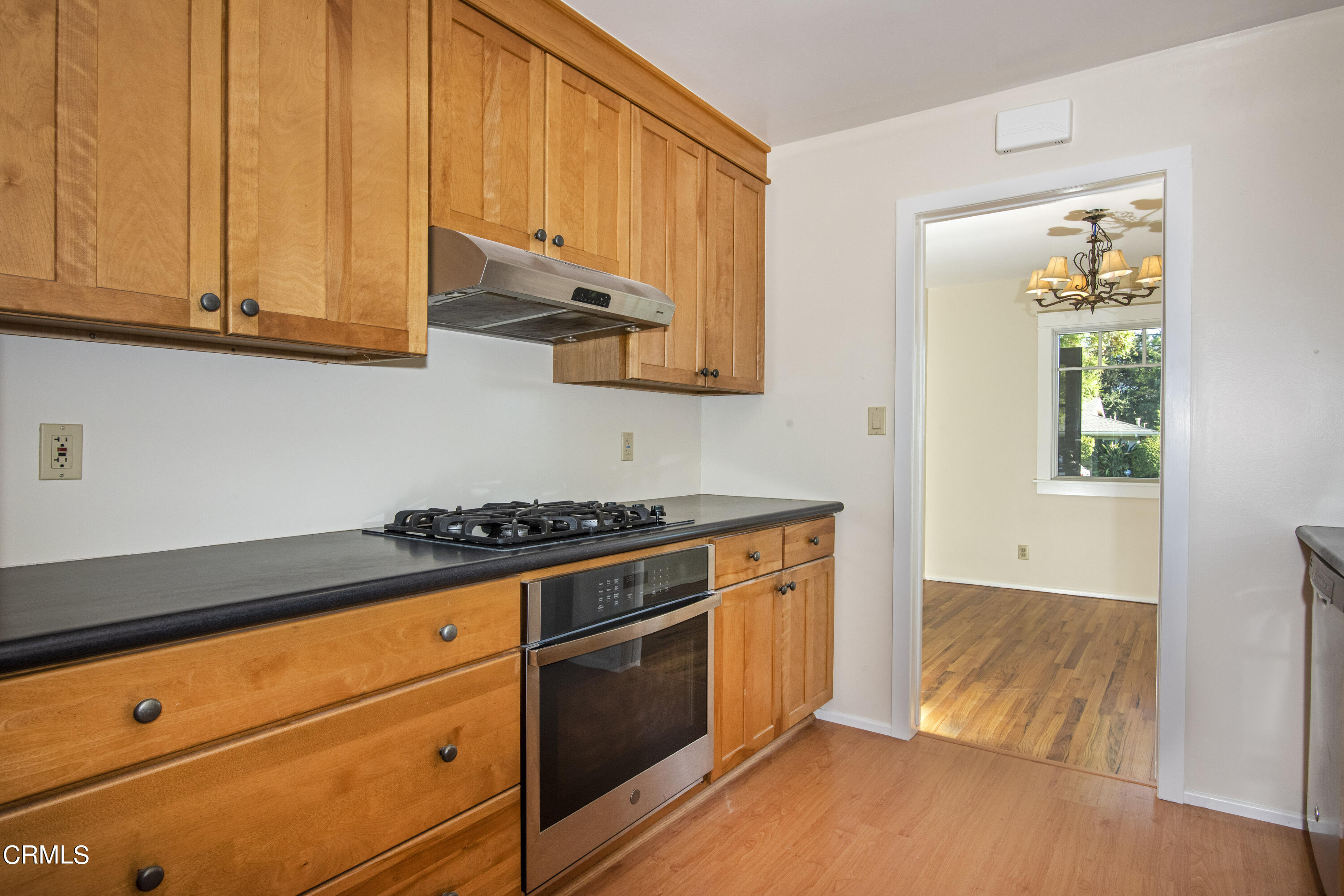 2901 Paloma Street Pasadena, CA 91107 - Photo 37 of 41 a kitchen with granite countertop wooden cabinets stainless steel appliances and a window
