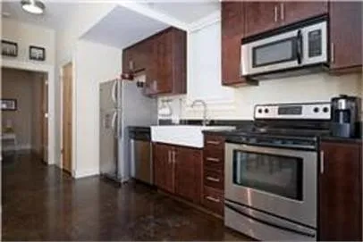 a kitchen with stainless steel appliances a stove microwave and refrigerator