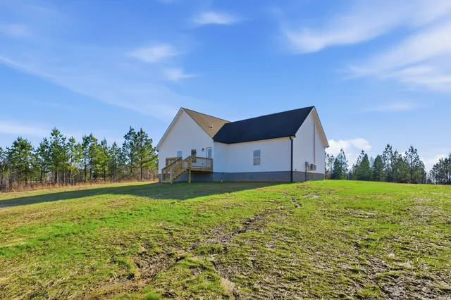 a house view with garden space and trees in the background
