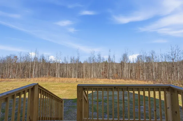 a view of swimming pool with a patio and wooden fence