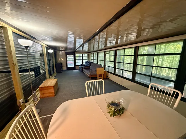 a bedroom with furniture and a large window