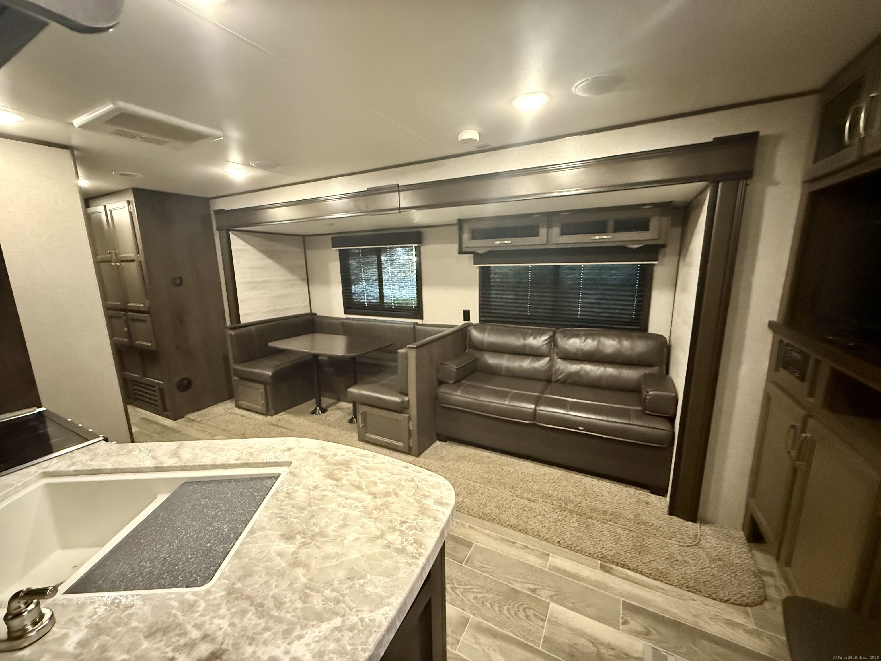 8 S Road, Unit R80 Stafford, CT 06076 - Photo 13 of 36 a living room with furniture and a flat screen tv