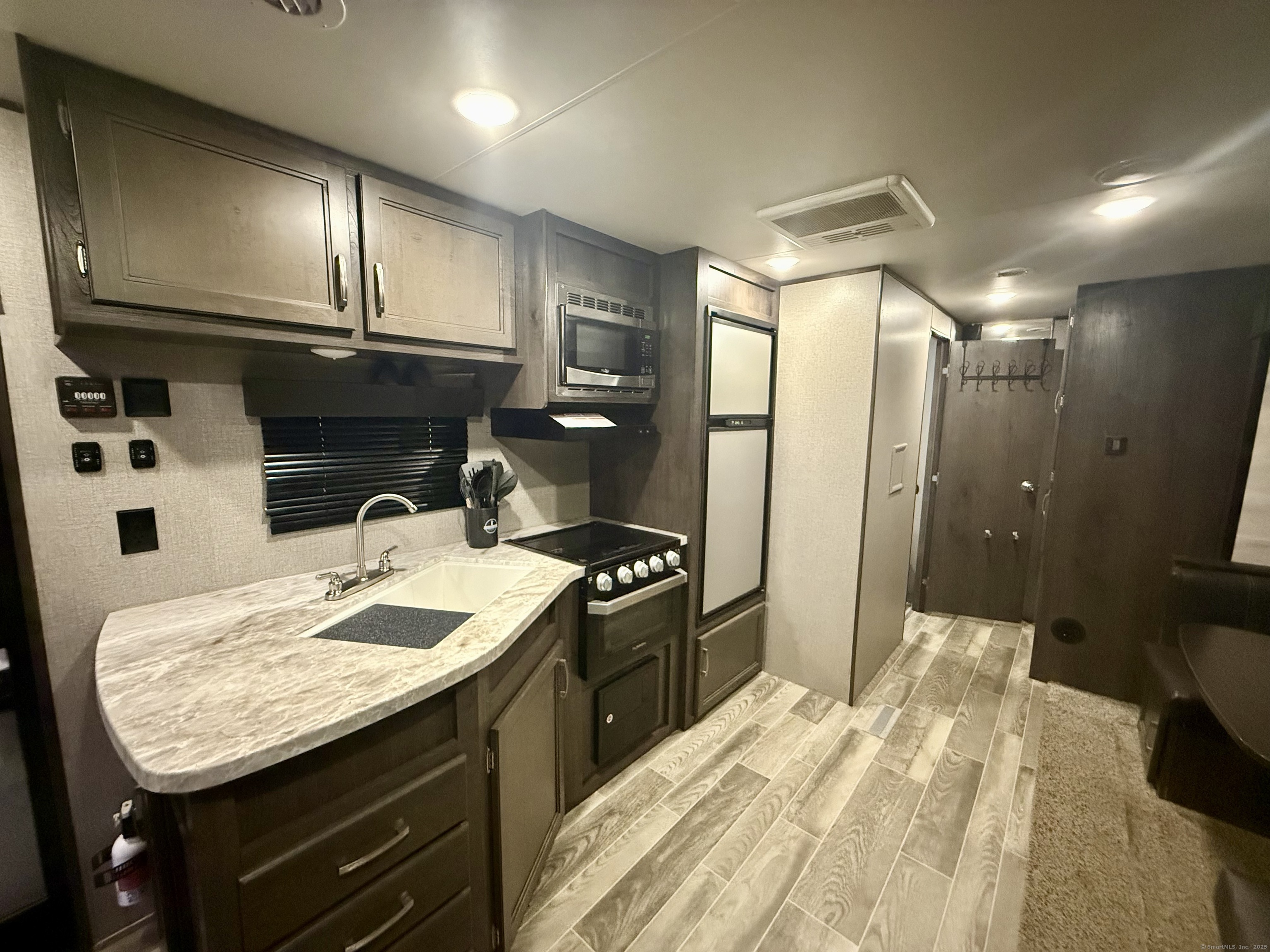 8 S Road, Unit R80 Stafford, CT 06076 - Photo 14 of 36 a kitchen with granite countertop stainless steel appliances a stove sink and cabinets