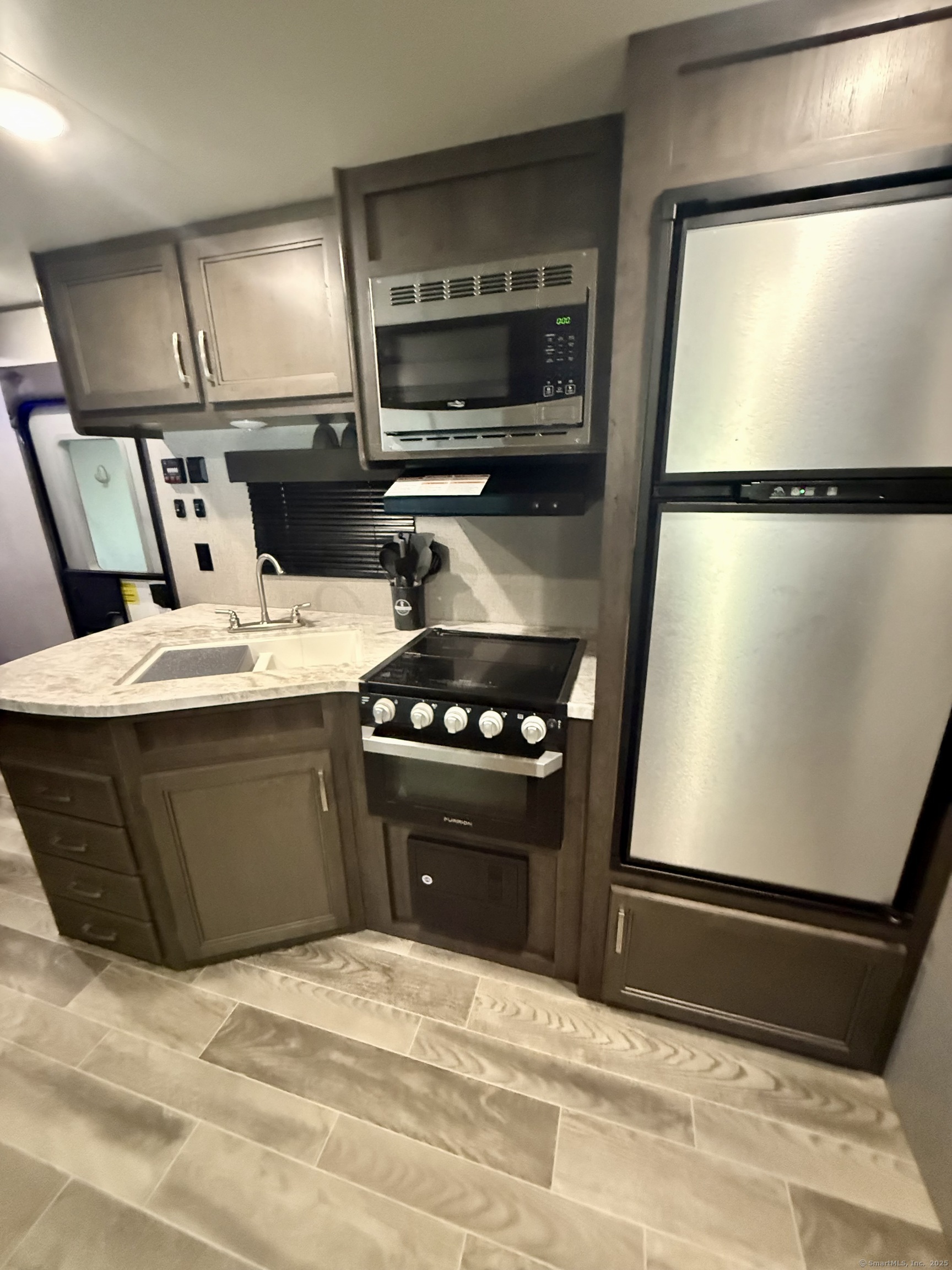 8 S Road, Unit R80 Stafford, CT 06076 - Photo 15 of 36 a kitchen with a refrigerator and a stove top oven