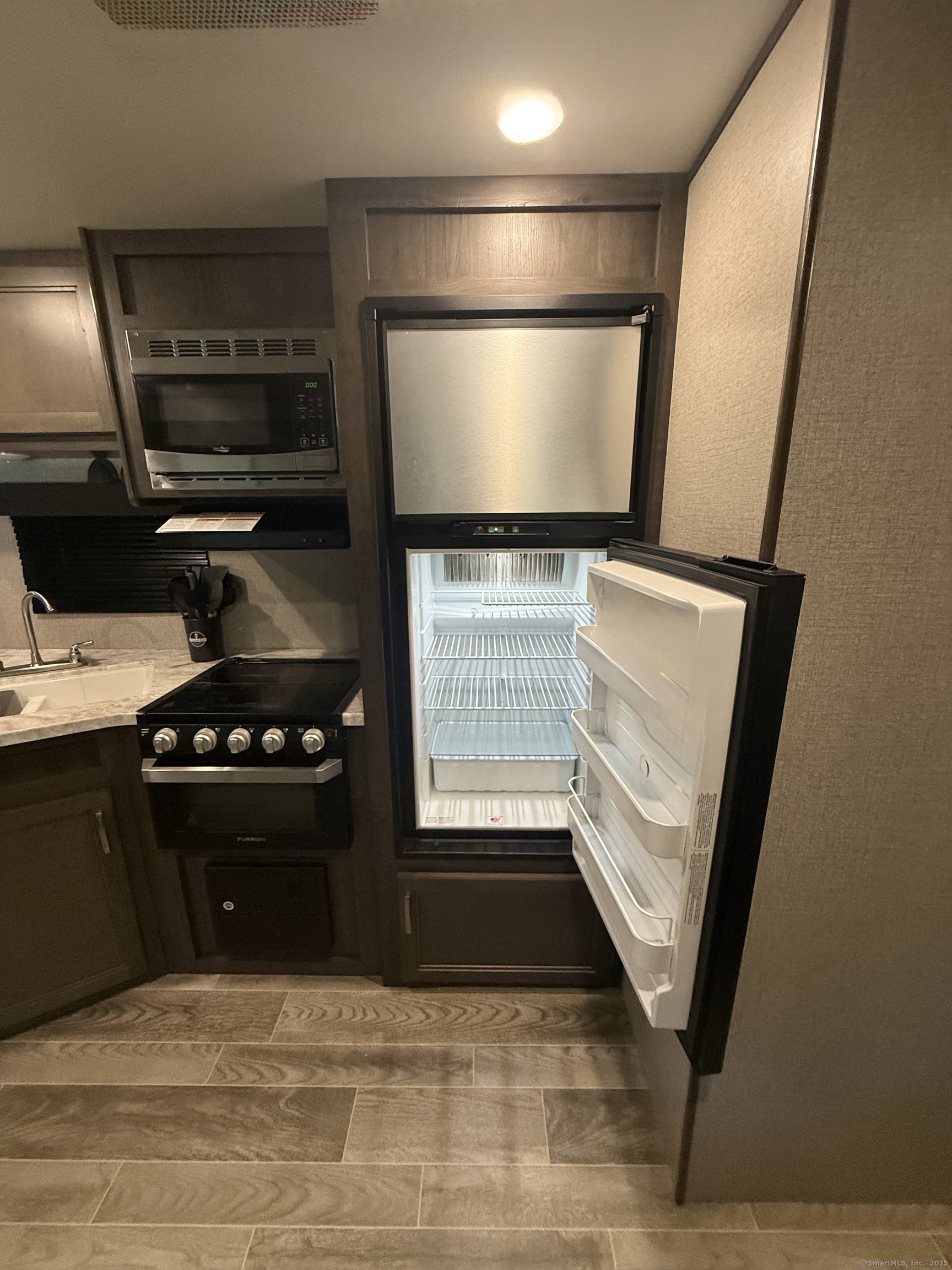 8 S Road, Unit R80 Stafford, CT 06076 - Photo 16 of 36 a kitchen with a refrigerator and a stove